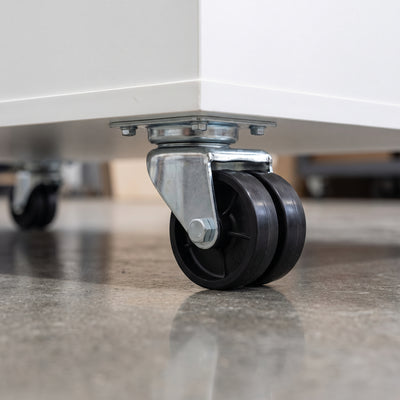 75mm twin wheel top plate castor with black polypropylene wheels fitted under a white mobile storage cabinet
