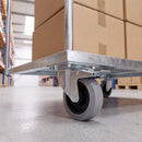 100mm braked castor with grey rubber wheel under a galvanised warehouse platform trolley