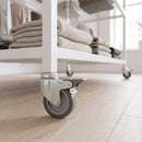 100mm braked grey rubber bolt hole castor on a retail shop display unit