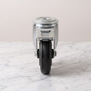 Front view of 100mm braked castor with black rubber tread, foot brake and 12mm bolt hole swivel head