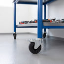 100mm black rubber braked bolt hole castor fitted to a blue steel workbench leg
