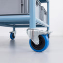 100mm blue non-marking braked bolt hole castors on a steel shelf trolley with crates