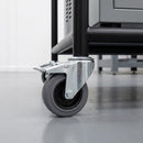 100mm braked grey rubber bolt hole castor on a black steel equipment stand