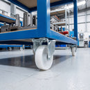 100mm fixed castor white nylon wheel fitted under a blue workshop cart carrying metal parts