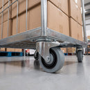 100mm noise-reducing braked castor grey rubber wheel bolted under a roll cage trolley with cardboard boxes