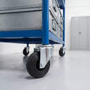 100mm black rubber swivel bolt hole castor fitted to a blue steel warehouse storage trolley