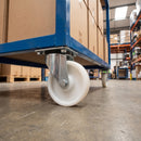 100mm swivel castor with white nylon wheel bolted with nuts under a blue industrial cart