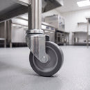 100mm swivel bolt hole castor grey rubber wheel fitted to a stainless steel catering table leg