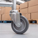 100mm grey rubber swivel castor with M10 bolt hole on a warehouse stock trolley