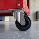 100mm swivel top plate castor with black rubber wheel under a red steel workshop tool trolley