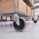 125mm grey rubber bolt hole castor on mobile wire shelving in a warehouse