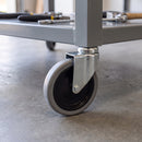 125mm swivel bolt hole castor with grey rubber wheel fitted to a mobile workbench tube leg