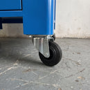 125mm swivel top plate castor with black rubber wheel under a blue steel workshop machine stand