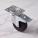 160mm braked swivel top plate castor black rubber wheel 150kg, high angle top-down view on grey marble