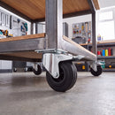 160mm braked castor with black rubber wheel bolted under a steel framed mobile workbench in a garage workshop