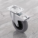 160mm braked swivel top plate castor grey rubber wheel 150kg, high angle view on grey marble