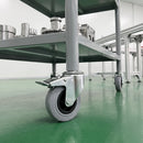 160mm braked grey rubber bolt hole castor on a grey steel assembly line parts trolley