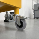 160mm braked grey rubber castor fitted to a yellow steel mobile machine base, 135kg load capacity