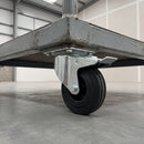 160mm braked top plate castor with black ribbed rubber wheel and total lock pedal bolted under a grey steel warehouse trolley