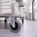 160mm swivel castors with grey rubber wheels under a stainless steel hotel laundry trolley