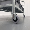 160mm grey rubber swivel bolt hole castor fitted to the tube leg of a steel platform trolley