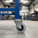160mm grey rubber bolt hole castor on a blue steel mobile machine base, 135kg load capacity