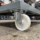 160mm swivel castor with white nylon wheel bolted with nuts under a factory assembly platform