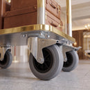 200mm braked castors with grey rubber wheels under a brass hotel luggage trolley