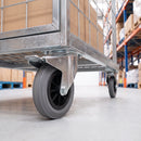 200mm braked castor with grey rubber wheel under a galvanised warehouse cage trolley