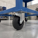 200mm braked top plate castor with black rubber wheel under a blue steel machine stand in a workshop