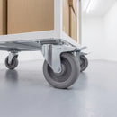 200mm braked top plate castor with grey TPR wheel under a white steel platform trolley in a storeroom