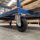 200mm directional lock castor with black rubber wheel under a blue steel platform truck carrying timber
