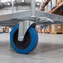 200mm directional lock castor with blue non-marking rubber wheel and lock catch bolted under a galvanised steel warehouse trolley