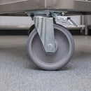 200mm directional lock castor with grey TPR wheel under a stainless steel catering trolley on a resin floor