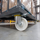 200mm directional lock castor white nylon wheel with roller bearing under a warehouse platform trolley with wrapped boxes