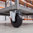 200mm fixed castor with black rubber wheel bolted under a steel warehouse platform trolley
