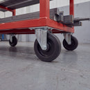 200mm fixed top plate castor with ribbed black rubber wheel under a red steel workshop trolley carrying bar stock