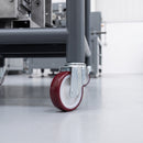 200mm red polyurethane bolt hole castor on a dark grey steel heavy-duty factory cart