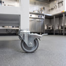50mm braked grey rubber M10 bolt hole castor fitted to a catering trolley in a commercial kitchen