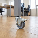 50mm braked grey rubber bolt hole castor fitted under a square tube leg in an office