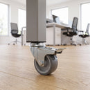 50mm braked grey rubber bolt hole castor fitted under a square tube leg in an office