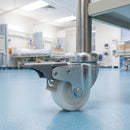 50mm braked white nylon bolt hole castor fitted to a medical trolley tube leg