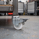 50mm braked white nylon bolt hole castor fitted to a mobile workbench in a workshop