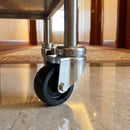 50mm black polypropylene swivel castor fitted to a hotel room service trolley