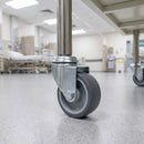 50mm grey rubber M10 bolt hole castor fitted to a medical trolley tube leg