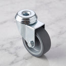 50mm swivel bolt hole castor with grey rubber wheel on light grey marble, high-angle three-quarter view