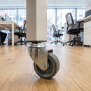50mm swivel bolt hole castor with grey rubber wheel fitted to an office unit leg