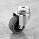 50mm swivel bolt hole castor with grey rubber tyre on black polypropylene centre on light grey marble, high-angle three-quarter view