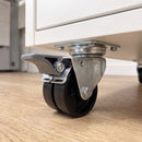 50mm twin wheel braked top plate castor with black wheels bolted under a white office drawer pedestal