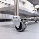50mm twin wheel braked grey rubber bolt hole castor fitted to a stainless steel catering table leg